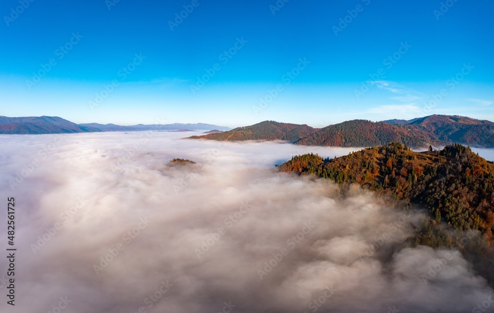 Fog among peaks of high autumn mountains with forests Fog among peaks of high autumn mountains with forests