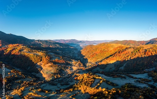 Highlands and hills with terracota forests under blue sky
