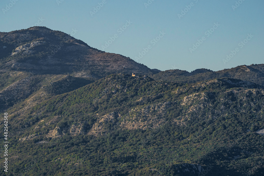 Mountain landscape in a haze with a lonely church.