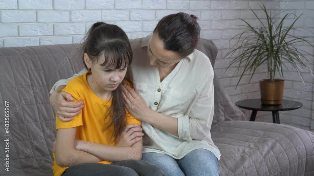 Depressed teenager. Mother hugs sad teenage daughter. Depressed teenager. Mother hugs sad teenage daughter.
