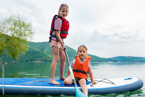Photography Girls padding on stand up paddle boarding on lake district