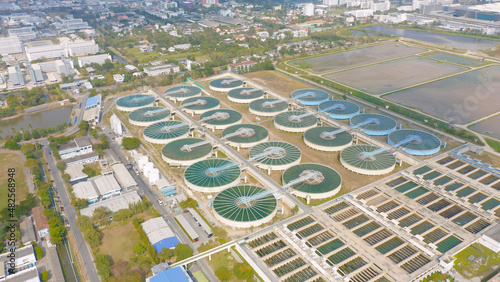 Aerial top view of metropolitan provincial waterworks industry factory in urban city town. Water utilities service. photo