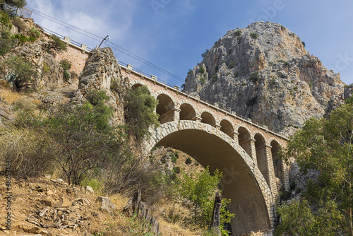 Under the railway bridge at the end of the King's pathway, high above the reservoir Tajo de la Encantada