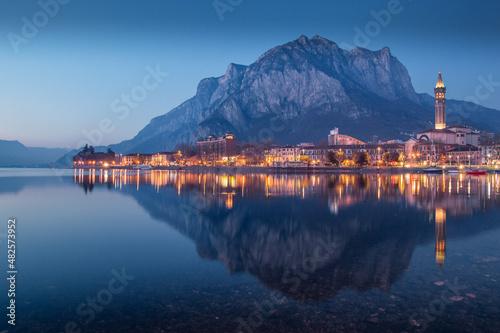 View of Lecco, Lombardy, reflecting on Como lake at blue hour, Italy
