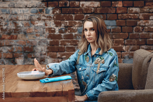 Fotografija Amazing pretty young and beautiful dieter lady in a cozy cafe says no to sweet cake