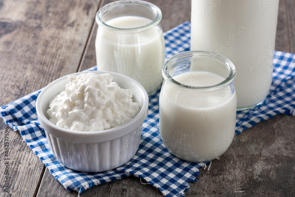 Milk kefir drink on wooden table. Liquid and fermented milk product on wooden table Milk kefir drink on wooden table. Liquid and fermented milk product on wooden table
