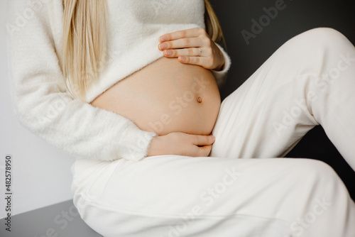 woman holding belly, pregnant woman.