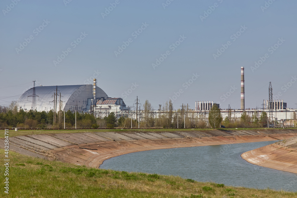 nuclear reactors of Chernobyl power plant next to Pripyat river, 4th exploded reactor with sarcophagus on left, 3th reactor on right, Exclusion zone, Ukraine