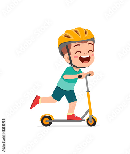 cute little boy riding scooter and wear helmet