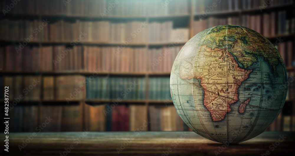 An old globe with Africa on the table against the background of bookcases. Concept on the topic of history, science, culture, education. - obrazy, fototapety, plakaty 