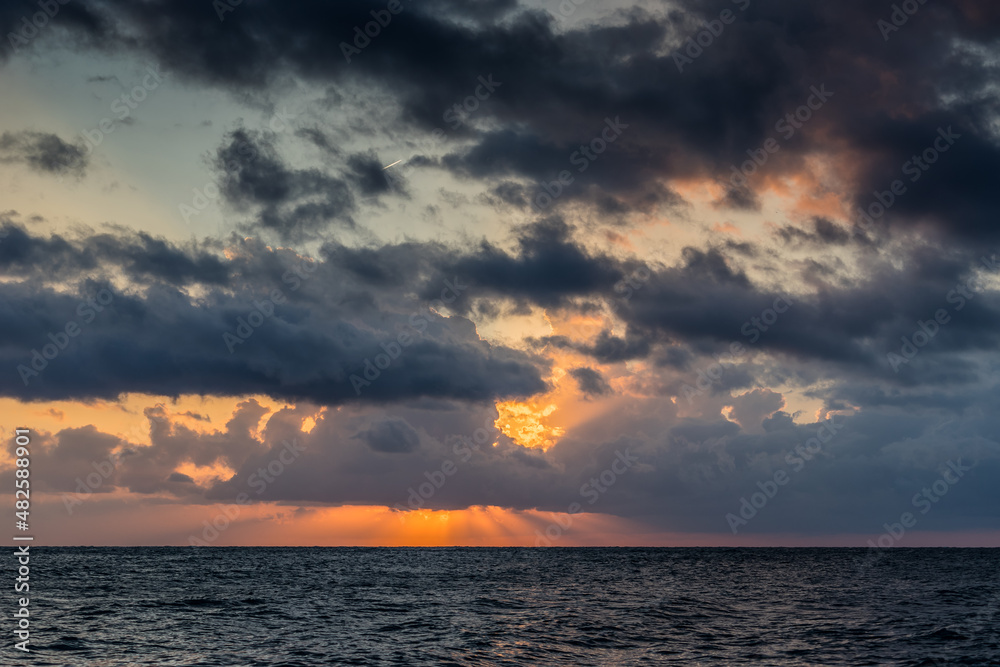 Seascape with a beautiful sunset over the surface of the sea