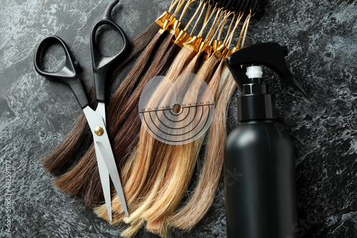 Composition with hair extension accessories on dark background photo