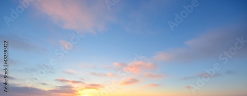 Clear blue sky with glowing pink and golden clouds after the storm. Dramatic sunset cloudscape. Concept art, meteorology, heaven, hope, peace. Graphic resources, picturesque panoramic scenery
