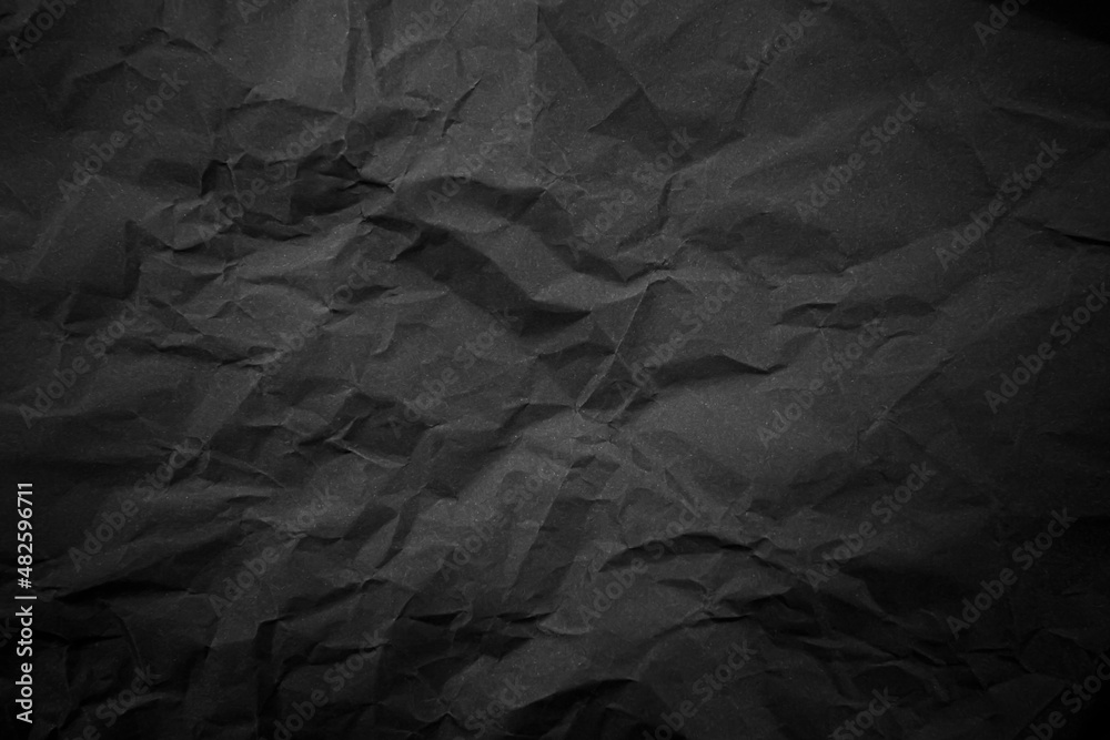 Textured crumpled black paper background. Textured crumpled black paper background.