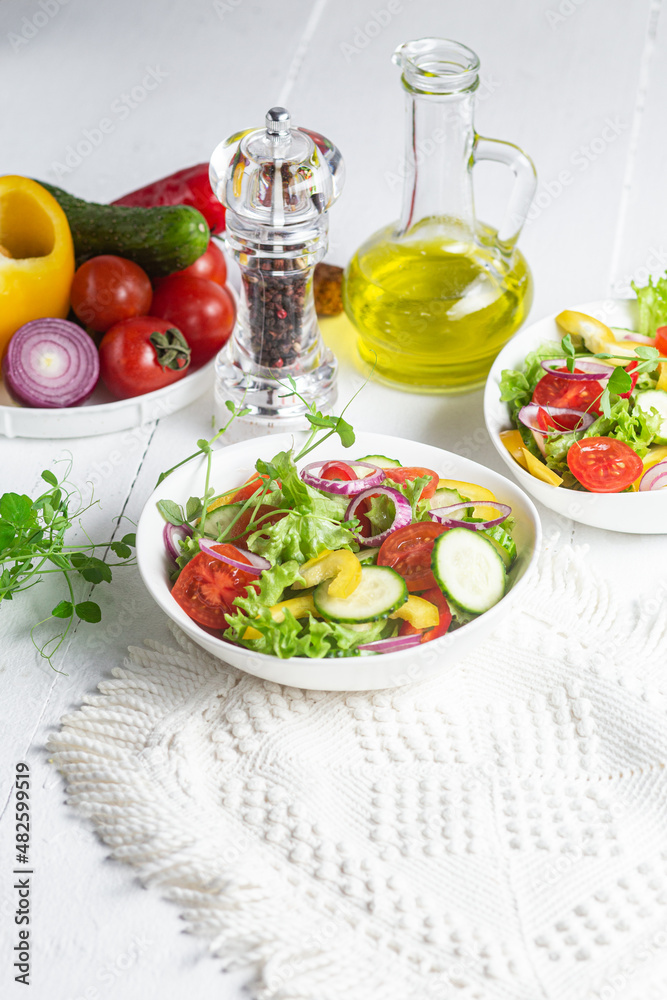 Vegetable salad with cucumber, tomato, sweet pepper in a white plate Vegetable salad with cucumber, tomato, sweet pepper in a white plate