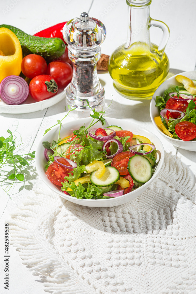 Vegetable salad with cucumber, tomato, sweet pepper in a white plate