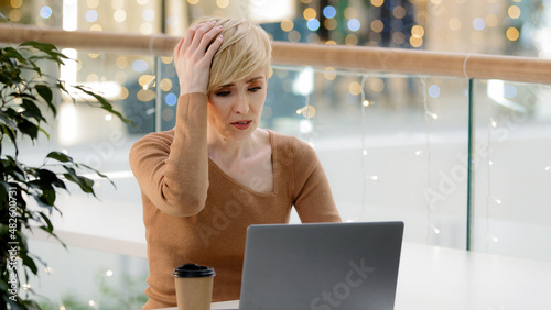 Φωτογραφία Caucasian middle aged mature 40s business woman with laptop working problems wit