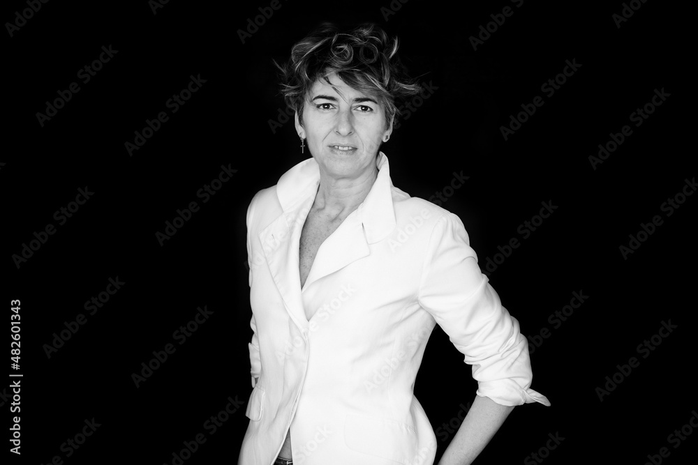 Woman With Short Disheveled Hair On A Black Background. 40-Year-Old Woman Posing For International Women's Day, March 8. Warrior Woman.