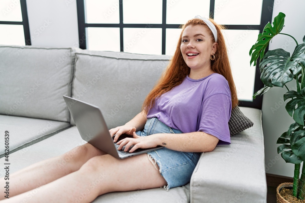 Young redhead woman smiling confident using laptop at home Young redhead woman smiling confident using laptop at home