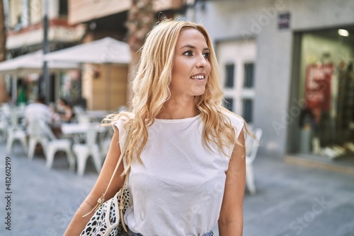 Young blonde woman smiling confident at street © Krakenimages.com