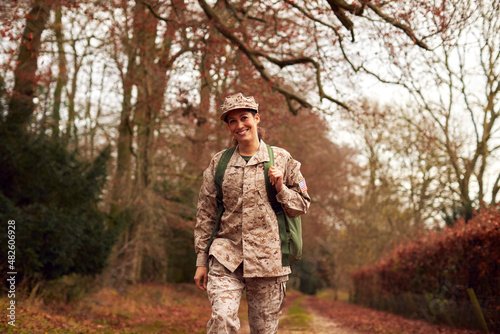 American Female Soldier In Uniform Carrying Kitbag Returning Home On Leave