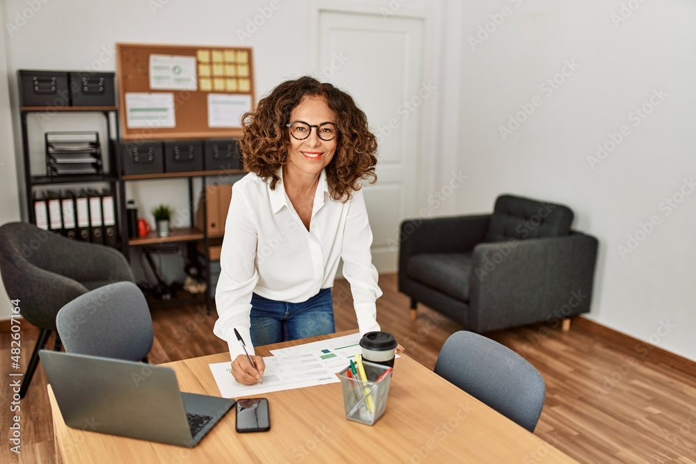 Mature hispanic woman working at the office Mature hispanic woman working at the office