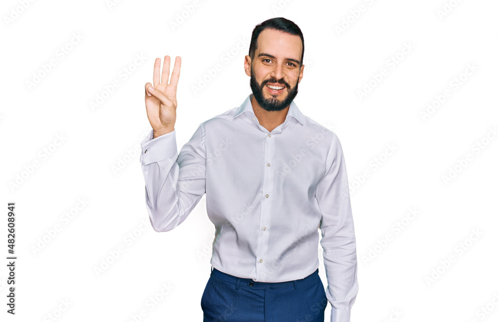 Young man with beard wearing business shirt showing and pointing up with fingers number three while smiling confident and happy.