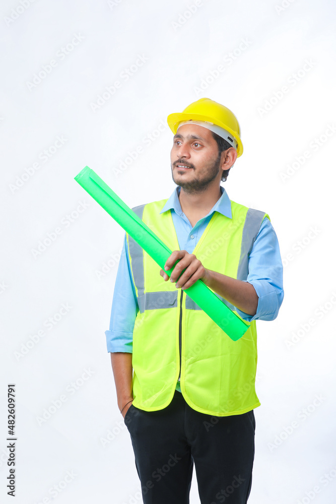 Young architect man with helmet and holding blueprints in hand. on white background. Young architect man with helmet and holding blueprints in hand. on white background.