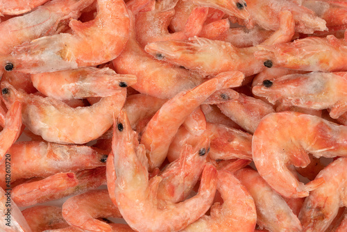 Unpeeled frozen shrimp background texture