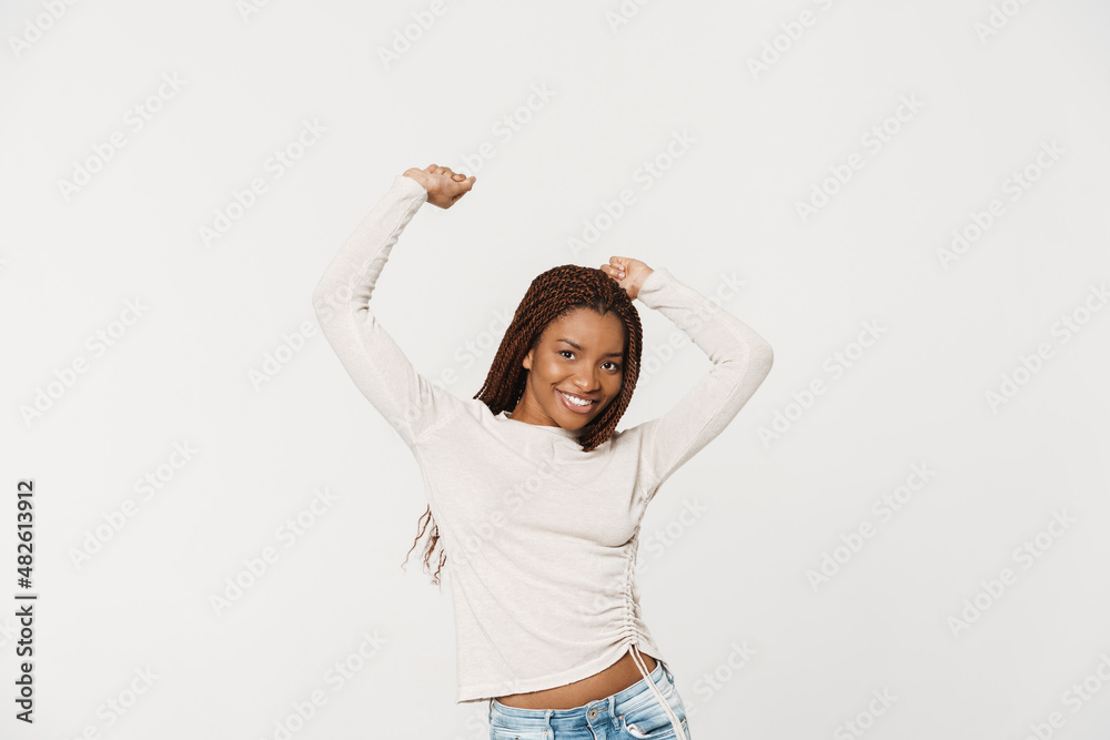 Young black woman with pigtails smiling while dancing on camera Young black woman with pigtails smiling while dancing on camera