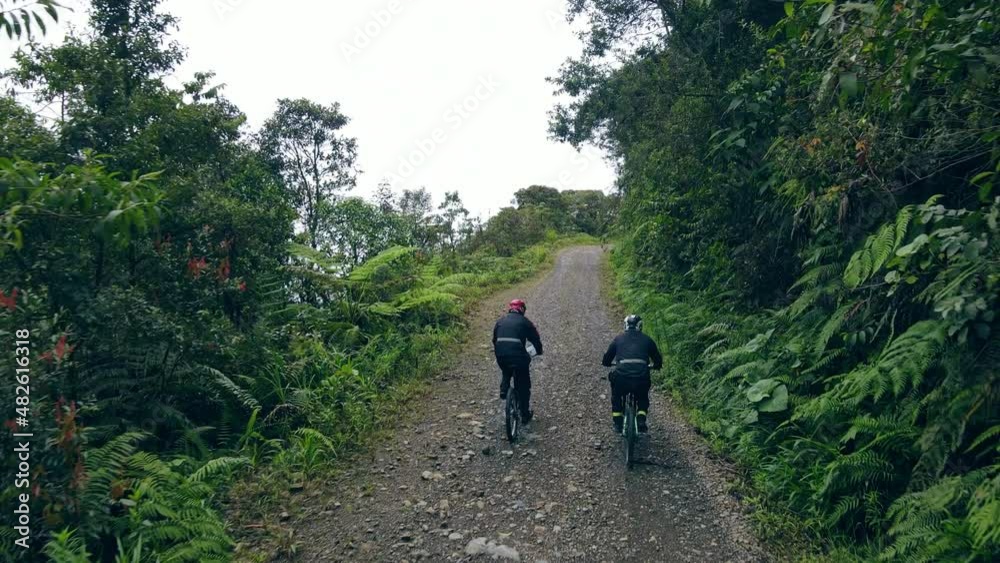 Aerial view of two mountain bikers riding on the Road of Death, Bolivia Aerial view of two mountain bikers riding on the Road of Death, Bolivia