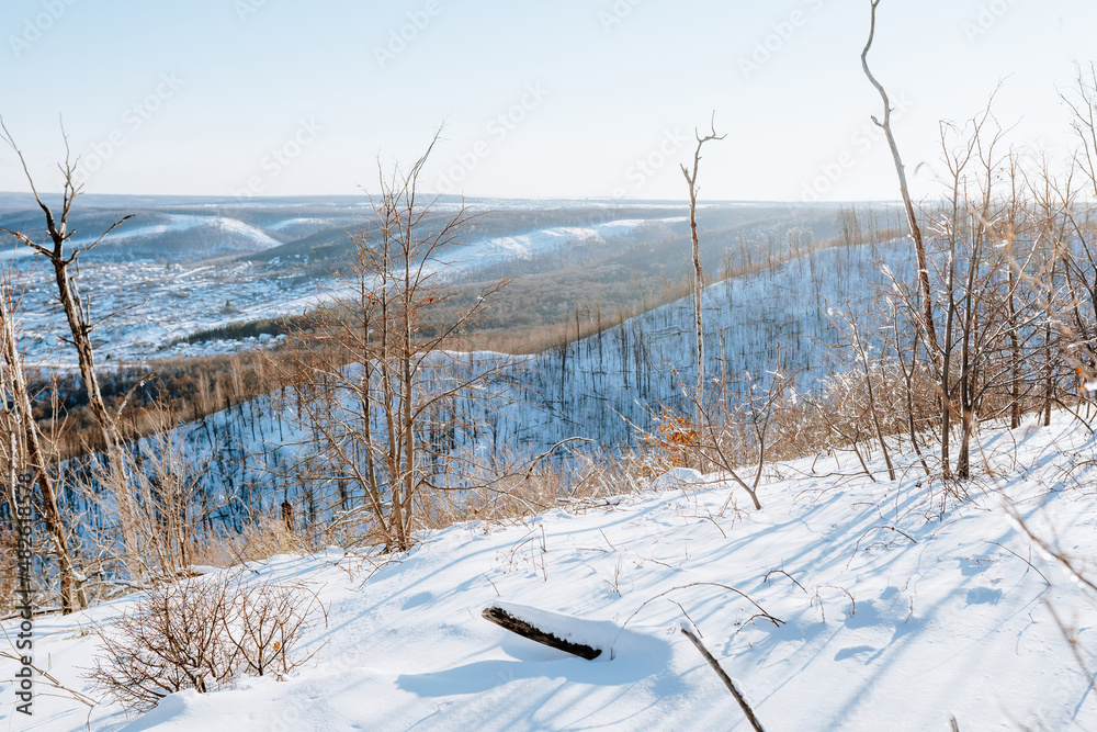 Amazing winter landscape in the mountains, top view. The snow lies on the mountains and the trees are covered with ice. Russia, Togliatti Amazing winter landscape in the mountains, top view. The snow lies on the mountains and the trees are covered with ice. Russia, Togliatti