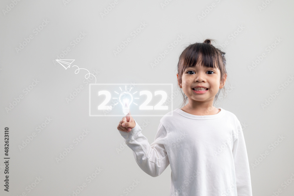 Happy cute little kids smiling and touching 2022 numbers isolated on white background for new year concepts Happy cute little kids smiling and touching 2022 numbers isolated on white background for new year concepts