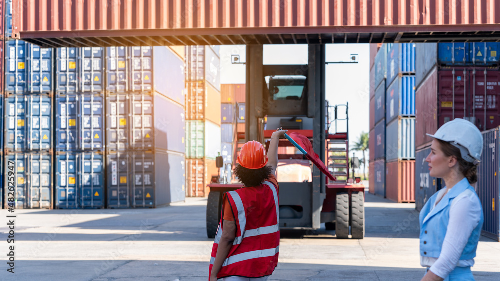 Foreman hold flag and wave the flag to stop forklift when CEO walk pass intront of Forklift