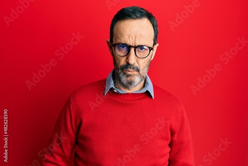 Middle age hispanic man wearing casual clothes and glasses depressed and worry for distress, crying angry and afraid. sad expression.