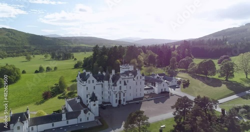 Aerial pull back shot revealing Blair Castle on a sunny day photo