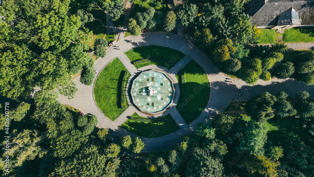 Aerial top view of a stone fountain on the square in the park in summer Aerial top view of a stone fountain on the square in the park in summer