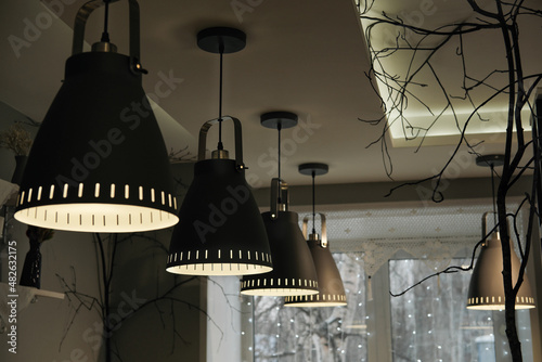 ceiling light lamps in evening cafe, night moody aesthetic, pendant lights, nordic style, simple design.