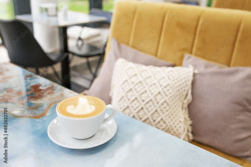 Cup of coffee against the backdrop of macramе decor lifestyle. Eco style. Natural cotton.