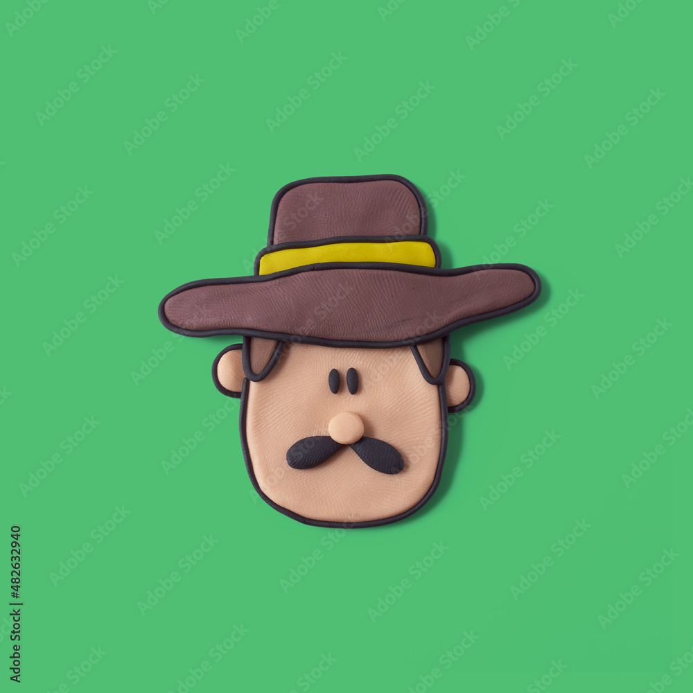 Farmer face with hat made of plasticine with isolated green background