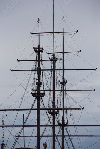 Bild auf Leinwand three wooden masts of a Dutch fluyt merchant sailing ship of XVIII century on a