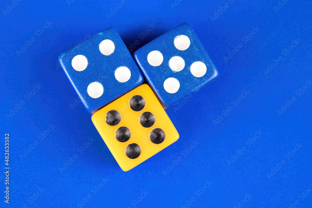 Blue and yellow dice over a solid background Blue and yellow dice over a solid background