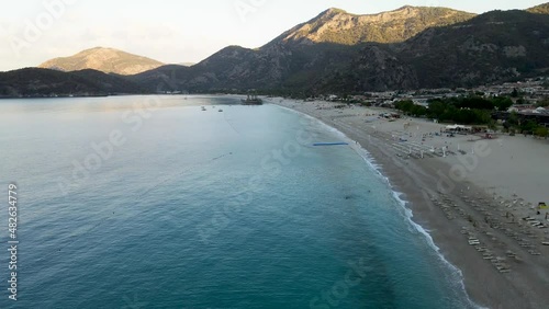 View from the drone from high to the Mediterranean Sea, mountains, people on the beach photo