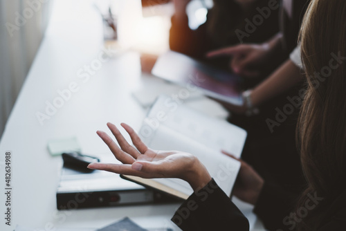 Business people meeting and analyst financial advisor preparing statistical report searching documents on work desk, browsing information online by digital tablet. photo