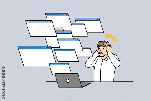 Technical problem and error concept. Stressed worker businessman sitting at laptop touching head looking at variety of pages windows screens vector illustration 