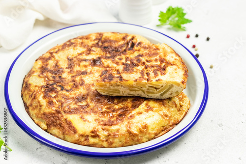 Spanish tortilla on light background. Space for text.