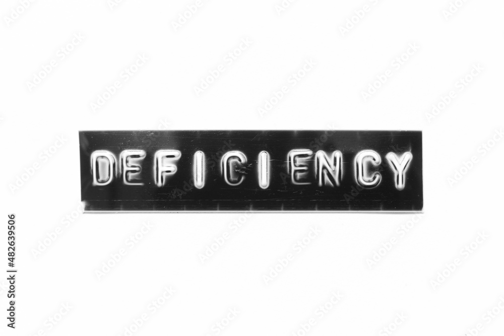 Embossed letter with word deficiency in black banner on white paper background Embossed letter with word deficiency in black banner on white paper background