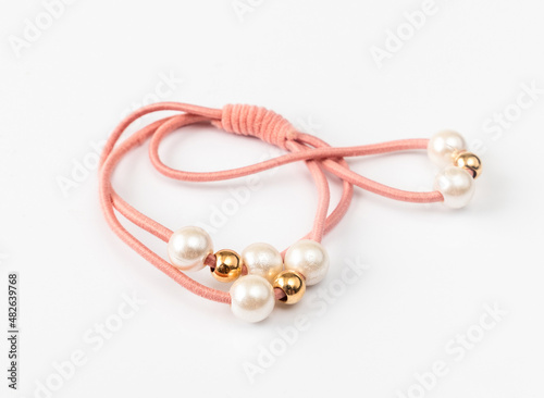 Hair band with pearls on a light background