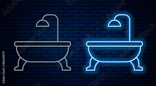 Glowing neon line Bathtub icon isolated on brick wall background. Vector