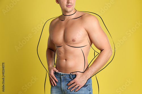 Obraz na plátně Athletic man after weight loss on yellow background, closeup view